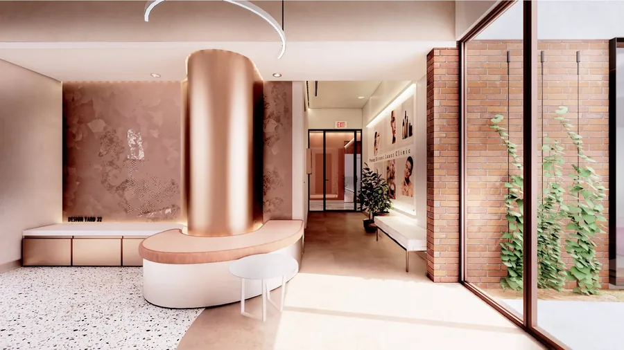 Rose-gold curved reception column and bench seating in a laser clinic waiting area with terrazzo flooring